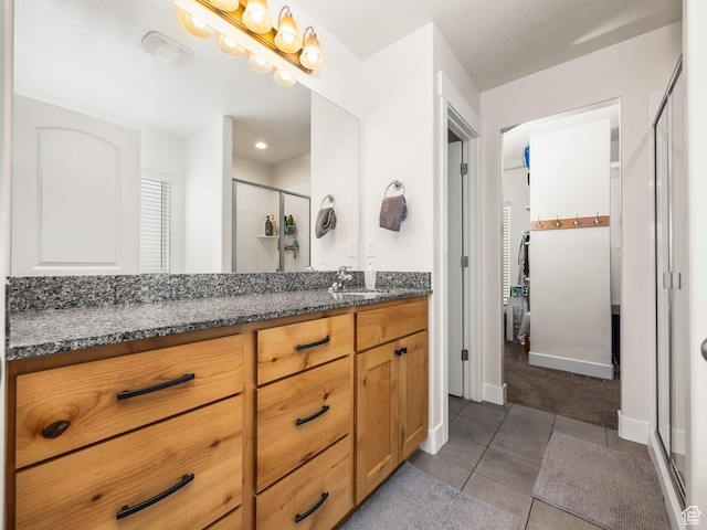 572 W Goosenest Dr, Elk Ridge, UT 84651 - full bath with vanity, a shower stall, tile patterned flooring, and baseboards