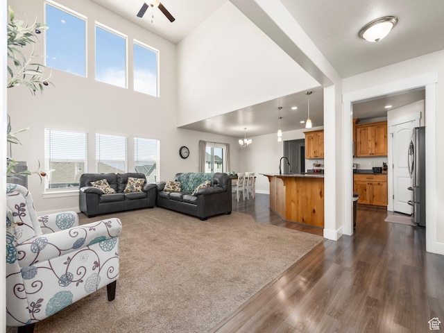 572 W Goosenest Dr, Elk Ridge, UT 84651 - living area with ceiling fan, dark wood-type flooring, a chandelier, healthy amount of natural light, and a towering ceiling