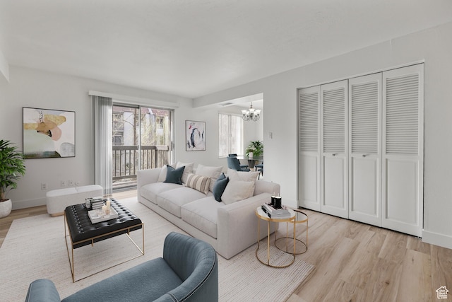 440 E Creekside Cir Unit D, Murray, UT 84107 - living area with a chandelier, light wood-style floors, and baseboards