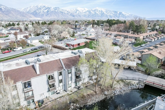 aerial view featuring a water and mountain view and a residential view