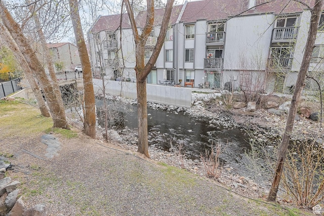 view of yard featuring a water view and fence