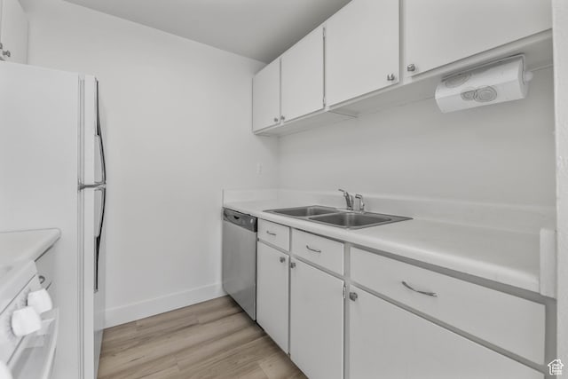 kitchen with baseboards, dishwasher, white cabinetry, and a sink