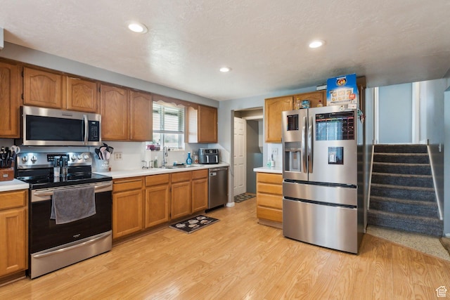2013 W Mark St, Layton, UT 84041 - kitchen featuring light countertops, light wood-type flooring, brown cabinets, recessed lighting, and stainless steel appliances
