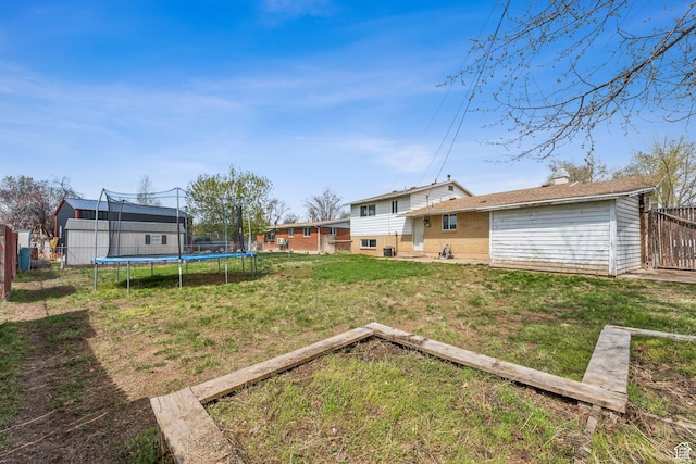 2013 W Mark St, Layton, UT 84041 - view of yard featuring a trampoline and fence