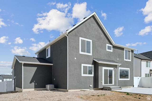 13 N N Maraschino Ln, Grantsville, UT 84029 - rear view of house with central air condition unit, a patio area, stucco siding, and fence