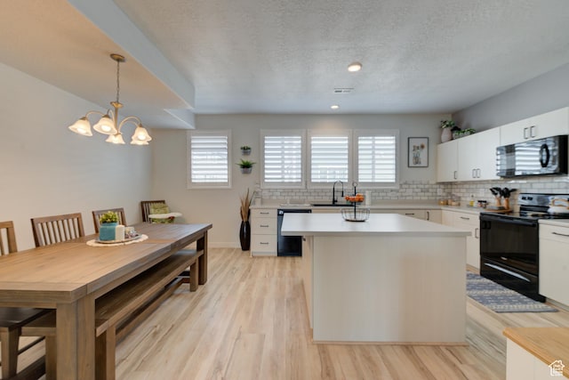 4696 W Talavera Way, Kearns, UT 84118 - kitchen featuring a sink, decorative backsplash, black appliances, and plenty of natural light