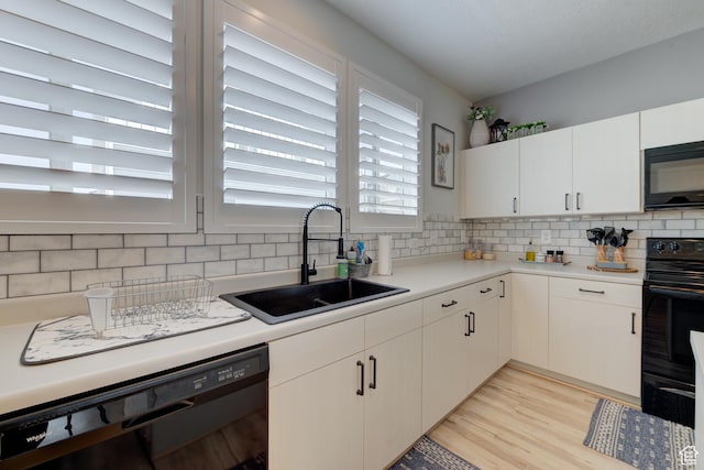 4696 W Talavera Way, Kearns, UT 84118 - kitchen with light countertops, tasteful backsplash, a sink, and black appliances