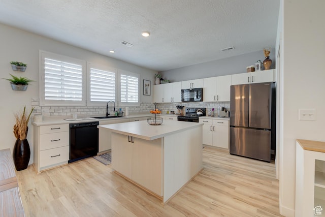 4696 W Talavera Way, Kearns, UT 84118 - kitchen featuring tasteful backsplash, visible vents, a sink, and black appliances