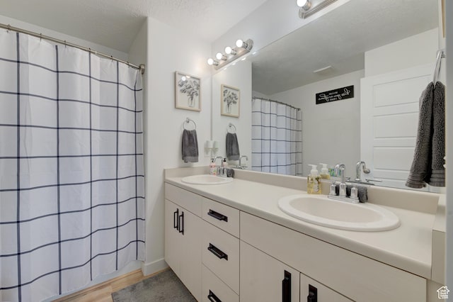 4696 W Talavera Way, Kearns, UT 84118 - full bath featuring wood finished floors, double vanity, and a sink