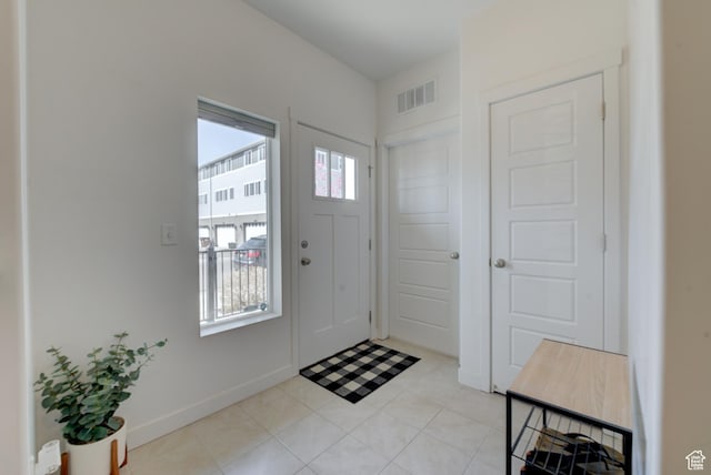 4696 W Talavera Way, Kearns, UT 84118 - entryway featuring light tile patterned flooring, baseboards, visible vents, and plenty of natural light