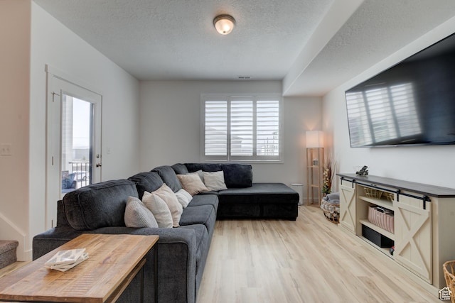 4696 W Talavera Way, Kearns, UT 84118 - living room with visible vents, light wood finished floors, and a textured ceiling