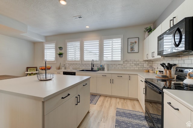 4696 W Talavera Way, Kearns, UT 84118 - kitchen featuring a sink, visible vents, black appliances, and a healthy amount of sunlight