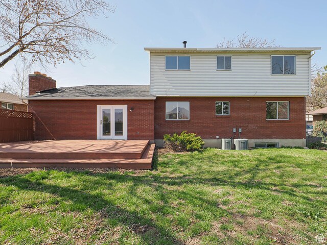 5085 Clover View Dr Unit 11, Murray, UT 84123 - back of house featuring brick siding, a wooden deck, and a lawn