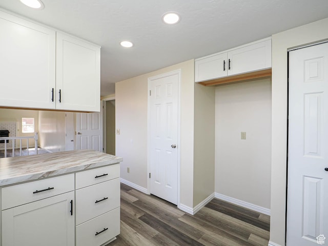 5085 Clover View Dr Unit 11, Murray, UT 84123 - kitchen featuring dark wood-style flooring, baseboards, light countertops, and white cabinetry