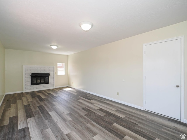 5085 Clover View Dr Unit 11, Murray, UT 84123 - unfurnished living room featuring baseboards, wood finished floors, and a fireplace