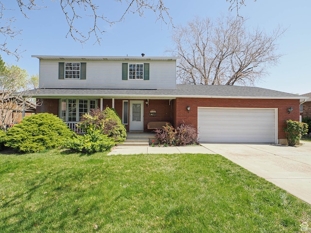 traditional home featuring brick siding, a front lawn, a garage, and concrete driveway