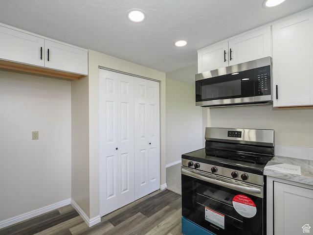5085 Clover View Dr Unit 11, Murray, UT 84123 - kitchen with baseboards, recessed lighting, white cabinetry, appliances with stainless steel finishes, and wood finished floors