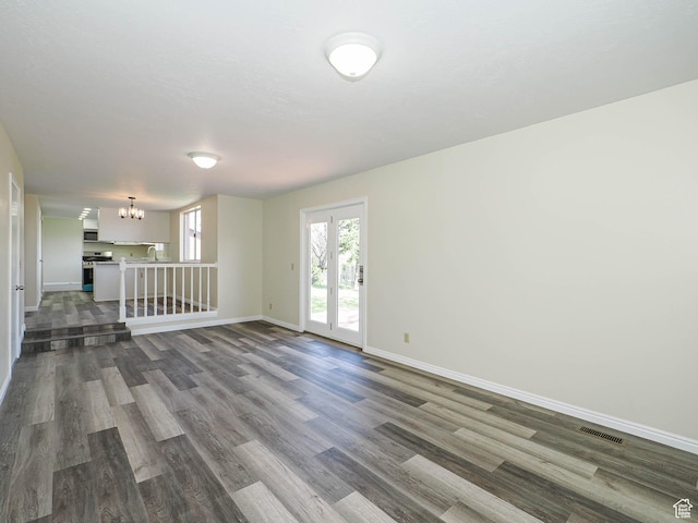 5085 Clover View Dr Unit 11, Murray, UT 84123 - unfurnished living room with visible vents, an inviting chandelier, and dark wood finished floors
