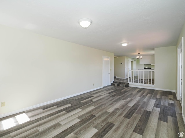5085 Clover View Dr Unit 11, Murray, UT 84123 - empty room with wood finished floors, a notable chandelier, and baseboards