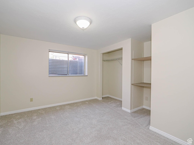 5085 Clover View Dr Unit 11, Murray, UT 84123 - unfurnished bedroom featuring a closet, baseboards, and light carpet