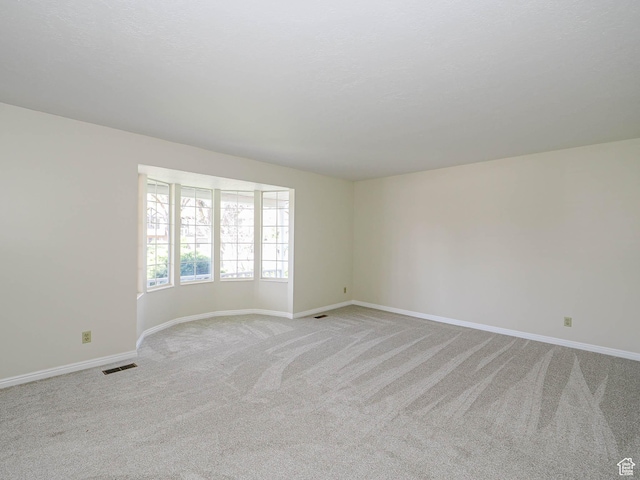 5085 Clover View Dr Unit 11, Murray, UT 84123 - spare room with visible vents, baseboards, and light colored carpet