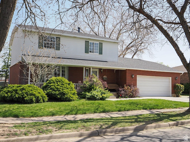 5085 Clover View Dr Unit 11, Murray, UT 84123 - traditional-style home with an attached garage, concrete driveway, a front yard, and brick siding