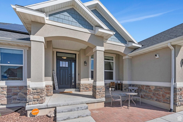 2155 E Blue Sky Dr, Eagle Mountain, UT 84005 - entrance to property with a shingled roof, stone siding, and stucco siding