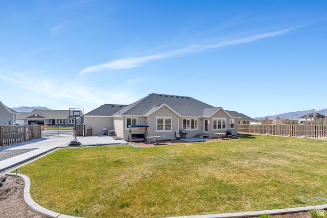 2155 E Blue Sky Dr, Eagle Mountain, UT 84005 - back of property featuring a yard, fence, a patio, and stucco siding