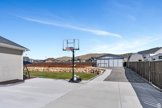 2155 E Blue Sky Dr, Eagle Mountain, UT 84005 - view of sport court featuring a residential view, a fenced backyard, and a lawn