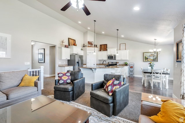 2155 E Blue Sky Dr, Eagle Mountain, UT 84005 - living area with ceiling fan with notable chandelier, high vaulted ceiling, baseboards, and recessed lighting
