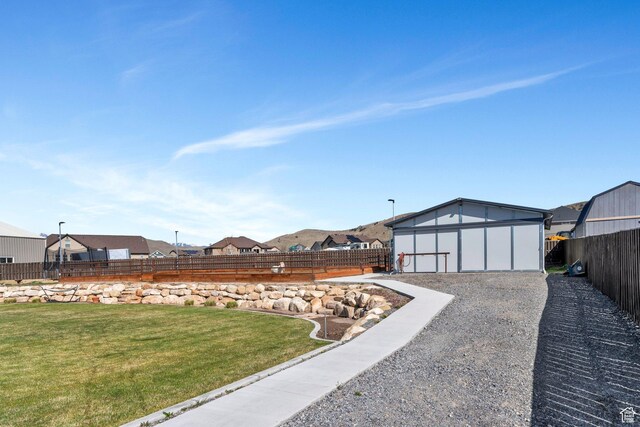 2155 E Blue Sky Dr, Eagle Mountain, UT 84005 - view of yard with a fenced backyard, a residential view, and an outdoor structure