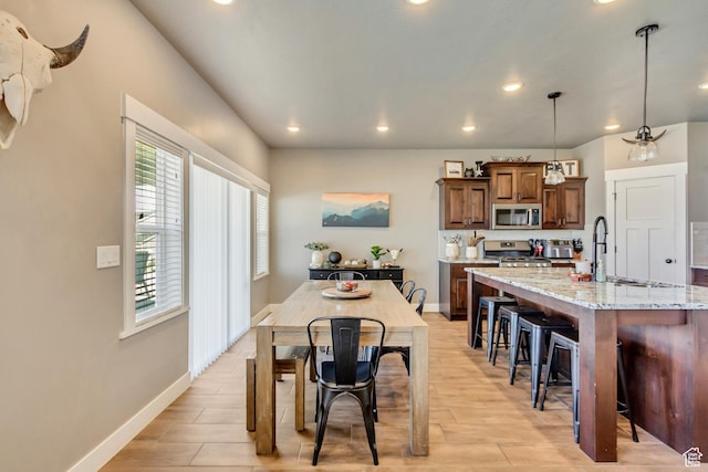 542 W Coyote Ridge Rd Unit 20, Grantsville, UT 84029 - kitchen featuring recessed lighting, pendant lighting, a breakfast bar area, and appliances with stainless steel finishes