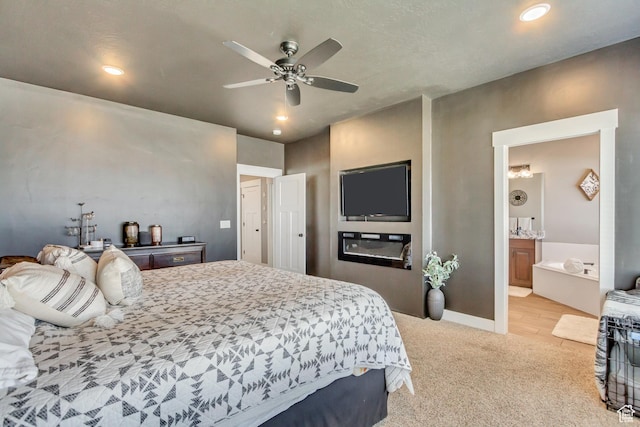 542 W Coyote Ridge Rd Unit 20, Grantsville, UT 84029 - bedroom with baseboards, a ceiling fan, recessed lighting, ensuite bath, and light carpet