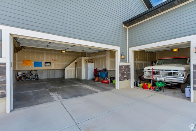 542 W Coyote Ridge Rd Unit 20, Grantsville, UT 84029 - garage featuring driveway