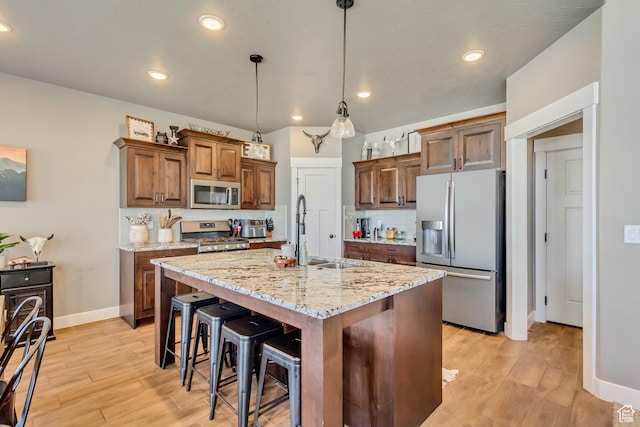 542 W Coyote Ridge Rd Unit 20, Grantsville, UT 84029 - kitchen featuring baseboards, backsplash, stainless steel appliances, light wood finished floors, and a sink