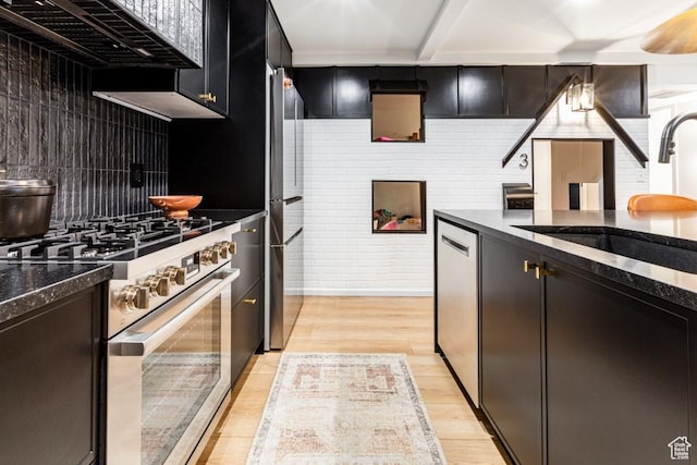 4155 S Parkview Dr, Salt Lake City, UT 84124 - kitchen with tasteful backsplash, dark stone countertops, a sink, light wood-type flooring, and stainless steel appliances
