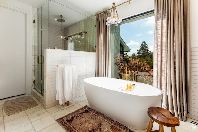 4155 S Parkview Dr, Salt Lake City, UT 84124 - bathroom with a chandelier, a freestanding bath, and a stall shower