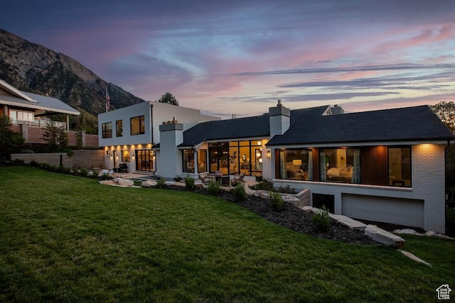 4155 S Parkview Dr, Salt Lake City, UT 84124 - back of house with a mountain view, a chimney, and a lawn
