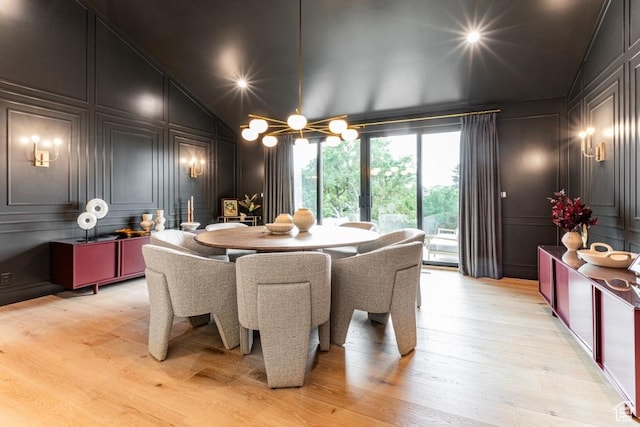 4155 S Parkview Dr, Salt Lake City, UT 84124 - dining area with light wood-type flooring, a decorative wall, high vaulted ceiling, and an inviting chandelier