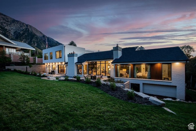 4155 S Parkview Dr, Salt Lake City, UT 84124 - rear view of house with a chimney, a mountain view, and a yard
