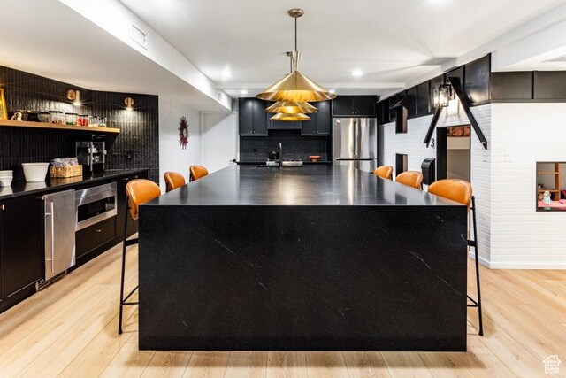 4155 S Parkview Dr, Salt Lake City, UT 84124 - bar featuring light wood-type flooring, a sink, pendant lighting, and stainless steel appliances