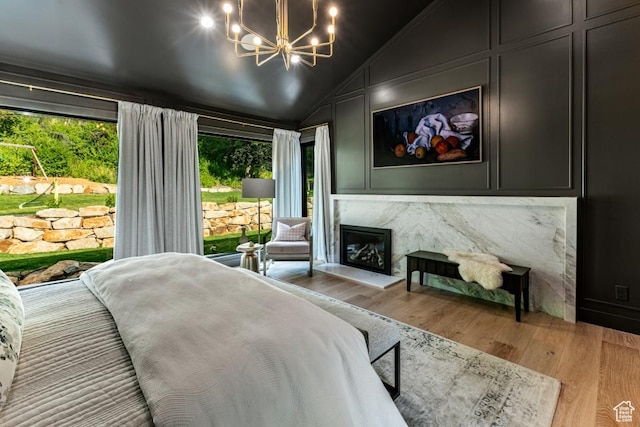 4155 S Parkview Dr, Salt Lake City, UT 84124 - bedroom featuring a chandelier, a fireplace, light wood-type flooring, and lofted ceiling