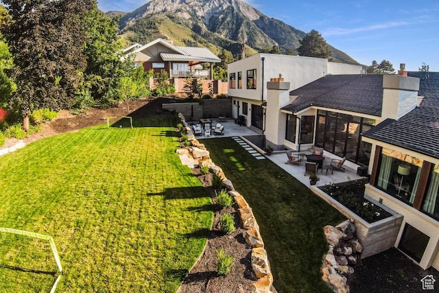 4155 S Parkview Dr, Salt Lake City, UT 84124 - rear view of property with a mountain view, a chimney, a patio area, and a lawn