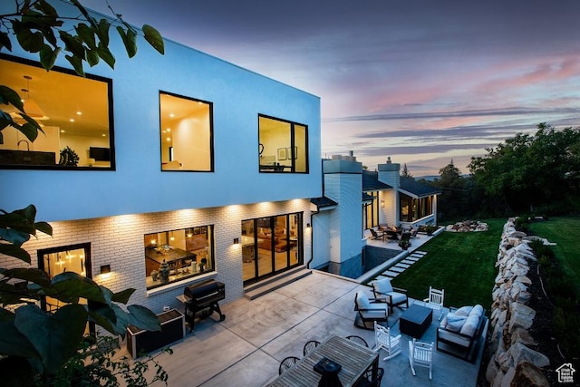 4155 S Parkview Dr, Salt Lake City, UT 84124 - back of house at dusk featuring an outdoor living space, brick siding, and a patio area
