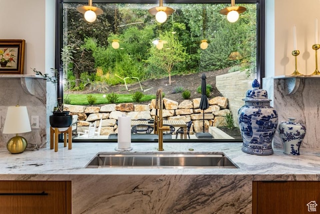 4155 S Parkview Dr, Salt Lake City, UT 84124 - interior space with light stone counters, a sink, and backsplash