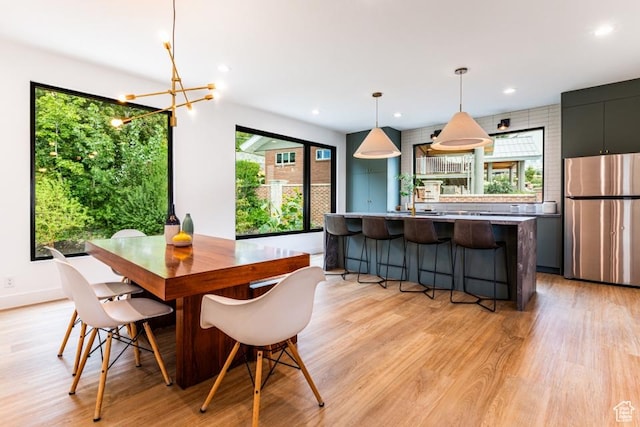 4155 S Parkview Dr, Salt Lake City, UT 84124 - dining space featuring light wood-style flooring, recessed lighting, a notable chandelier, and baseboards