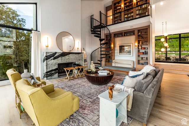 4155 S Parkview Dr, Salt Lake City, UT 84124 - living area featuring a fireplace, stairs, a towering ceiling, and wood finished floors