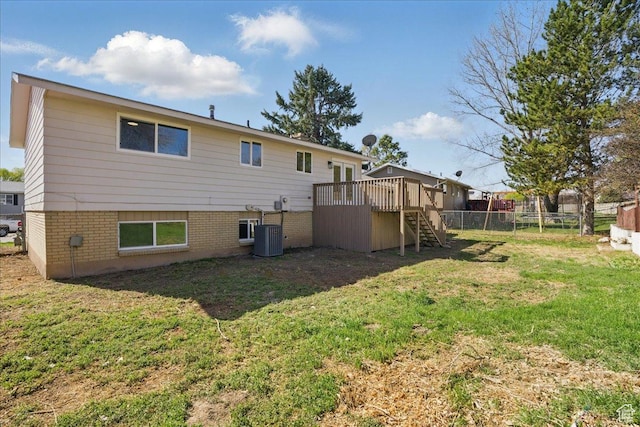 rear view of house featuring a yard, stairway, central AC unit, fence, and a deck