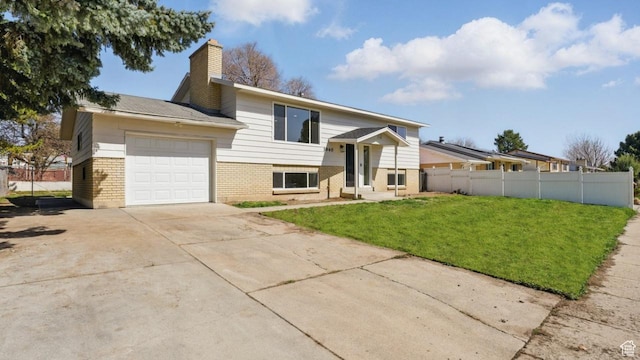 view of front of home with fence, a front lawn, brick siding, a garage, and driveway