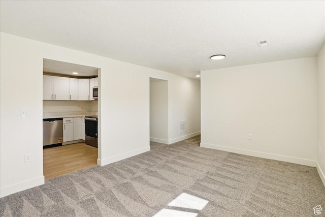unfurnished living room with light colored carpet, baseboards, visible vents, and recessed lighting